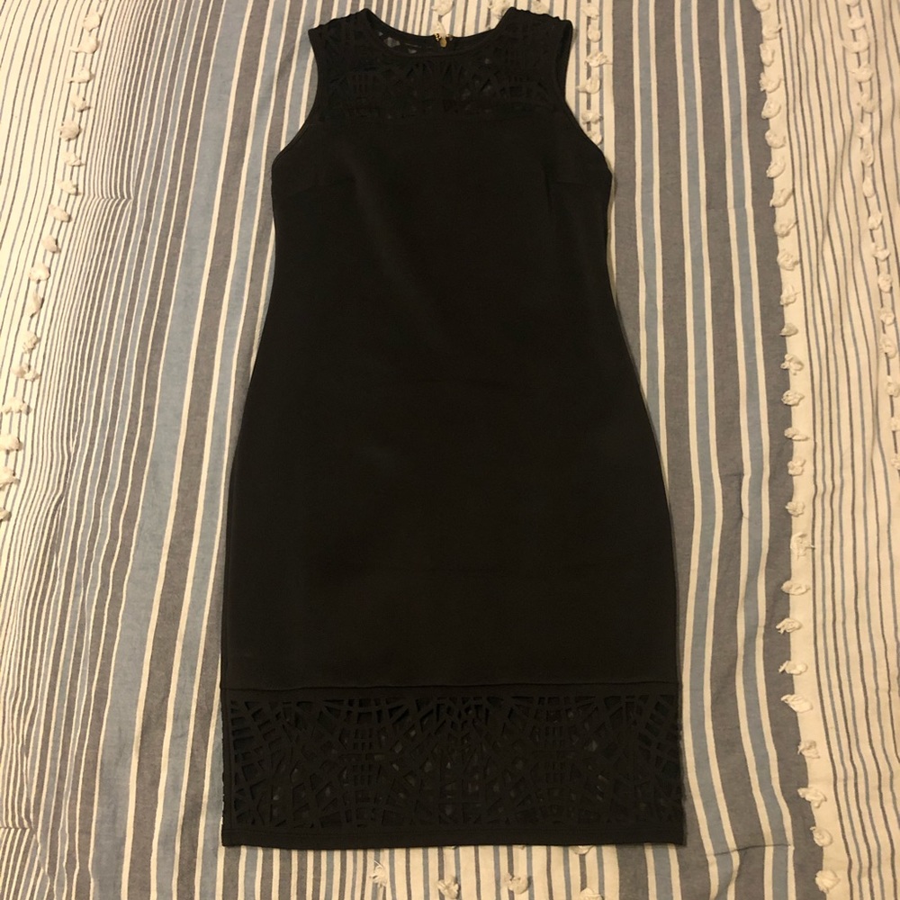 Fitted black dress with lace design.